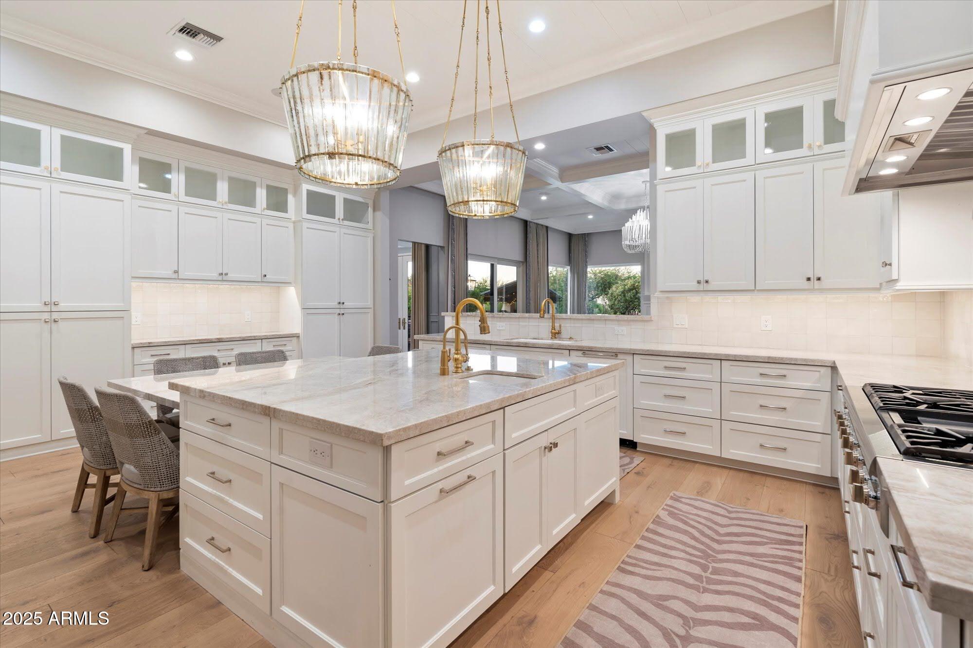 5226 East Desert Vista Road Paradise Valley, AZ 85253 - Photo 15 of 49 a kitchen with kitchen island granite countertop a sink cabinets and stainless steel appliances