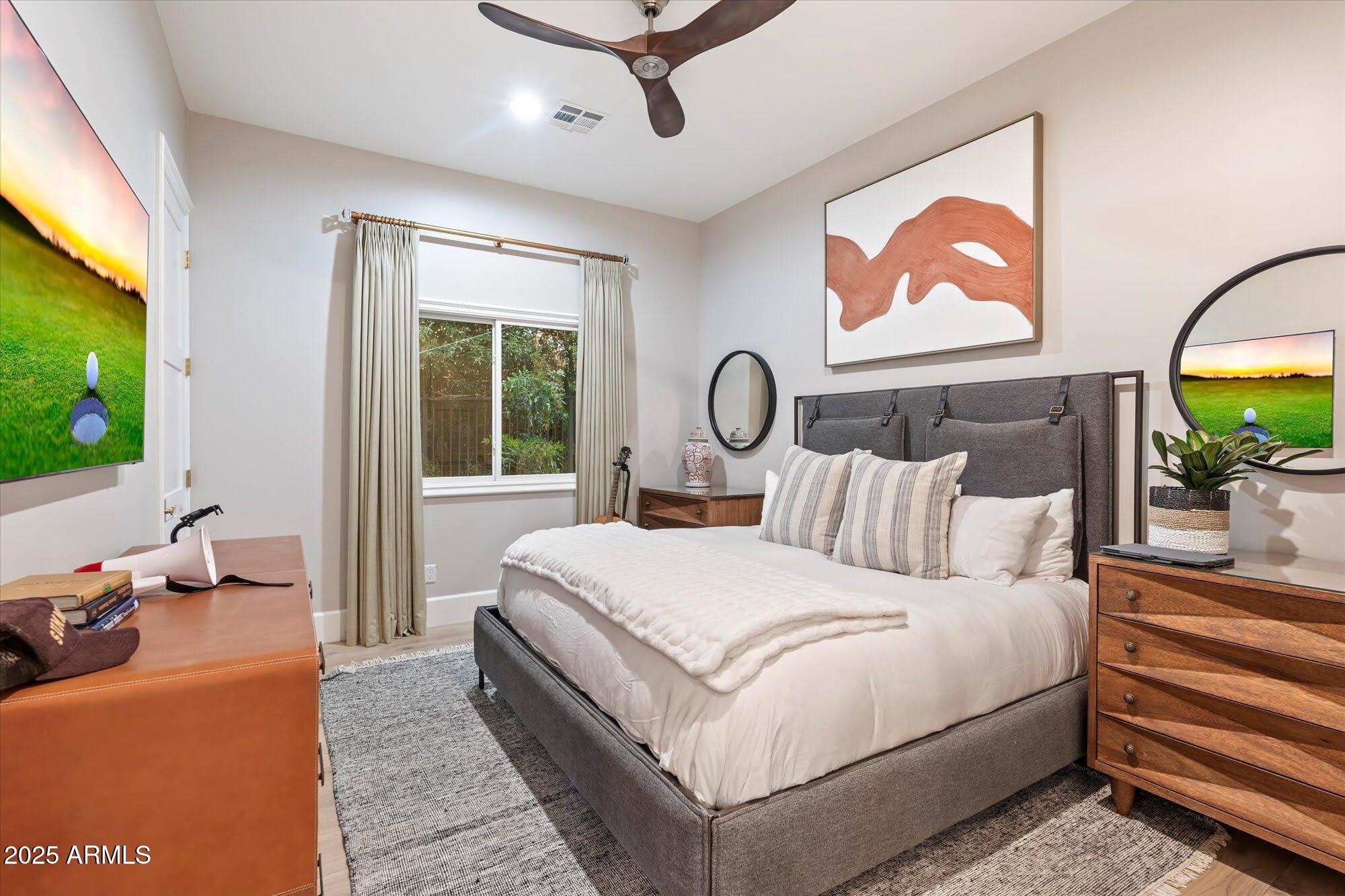 5226 East Desert Vista Road Paradise Valley, AZ 85253 - Photo 43 of 49 a bedroom with a bed and a flat screen tv