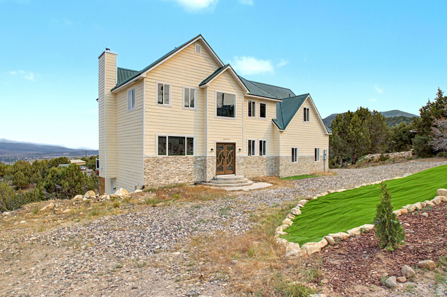 12645 East Cedar Ridge Drive Fairview, UT 84629 - Photo 29 of 34 Multi-story residence featuring light-colored siding and a green metal roof
