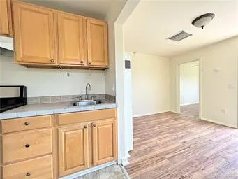 a kitchen with granite countertop white cabinets and sink