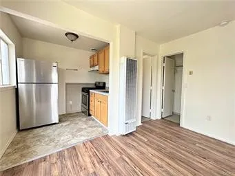 a kitchen with stainless steel appliances granite countertop a refrigerator and a stove top oven