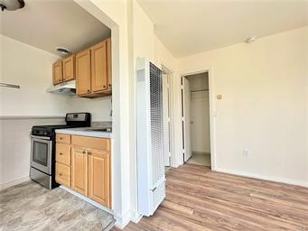 15962 M Street, Unit A Mojave, CA 93501 - Photo 14 of 21 a kitchen with stainless steel appliances granite countertop a refrigerator and a stove top oven