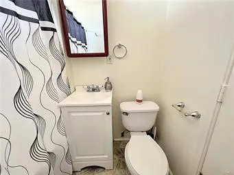 a bathroom with a sink and mirror with toilet