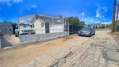 a view of a house with a small yard and wooden fence