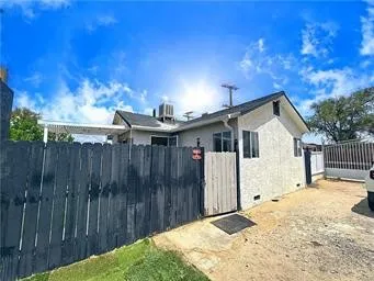 a view of backyard with wooden fence