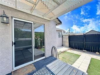 15962 M Street, Unit A Mojave, CA 93501 - Photo 7 of 21 a view of a backyard with table and chairs with wooden floor and fence