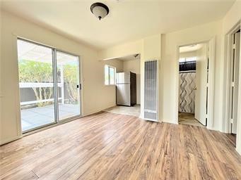 15962 M Street, Unit A Mojave, CA 93501 - Photo 9 of 21 an empty room with wooden floor and windows