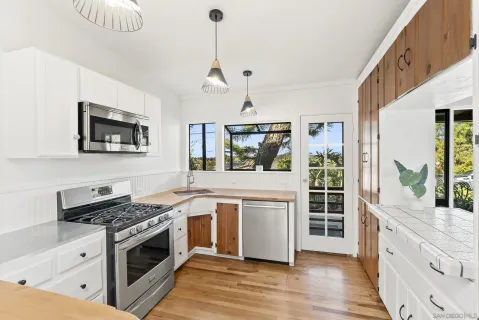 a kitchen with a sink a stove and microwave
