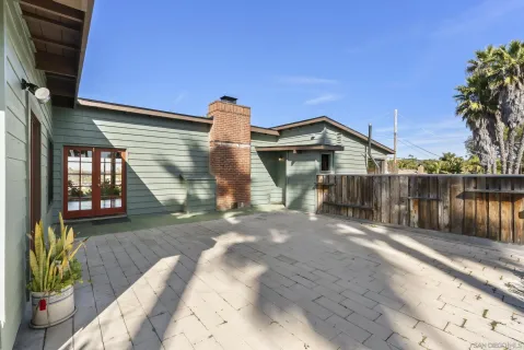 a view of a house with a yard and potted plants