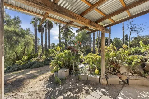 aerial view of a house with yard and trees around