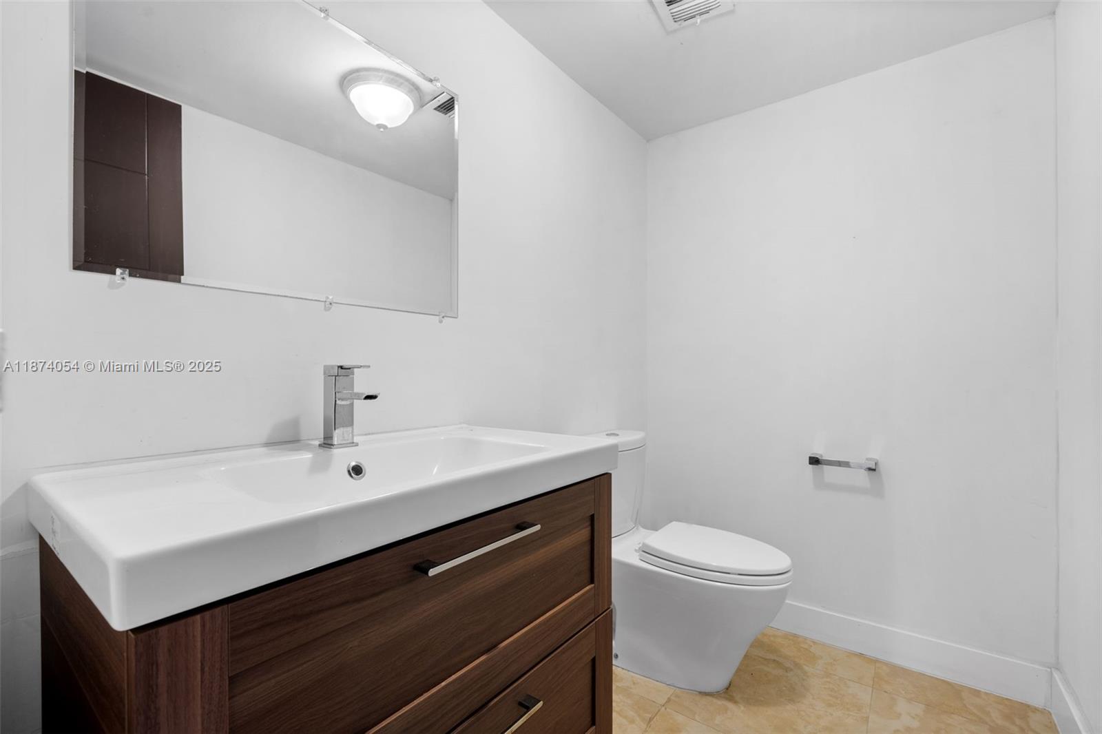 13499 Biscayne Boulevard, Unit 503 North Miami, FL 33181 - Photo 15 of 22 a bathroom with a sink toilet and mirror