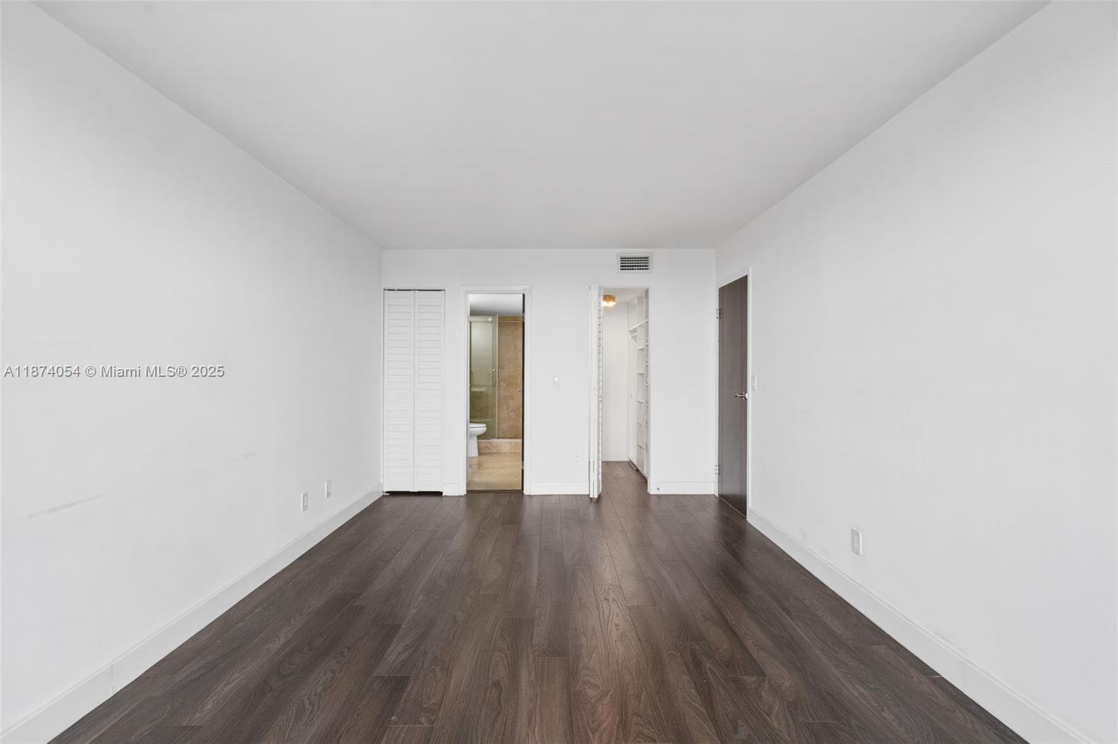 13499 Biscayne Boulevard, Unit 503 North Miami, FL 33181 - Photo 20 of 22 a view of an empty room with wooden floor