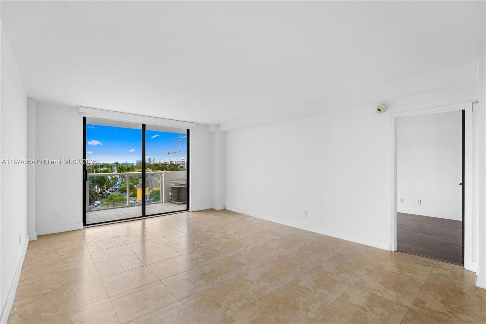 13499 Biscayne Boulevard, Unit 503 North Miami, FL 33181 - Photo 6 of 22 an empty room with sliding glass door and shower