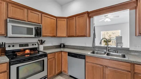 a kitchen with stainless steel appliances a stove a sink and cabinets