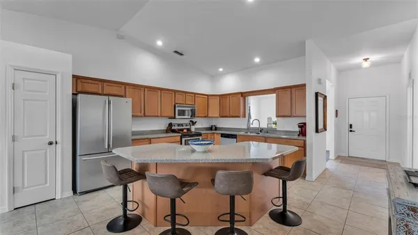 a large kitchen with a table and chairs