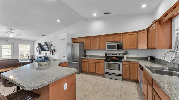 a kitchen with a sink stove top oven and microwave