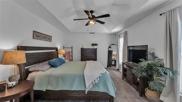 a bedroom with a bed window and a chair