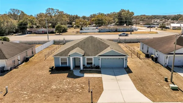 a view of a house with cars park