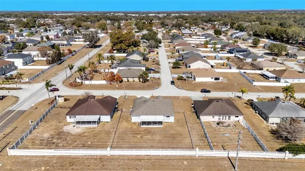 an aerial view of residential houses with city view