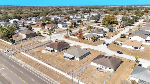 an aerial view of residential houses with yard