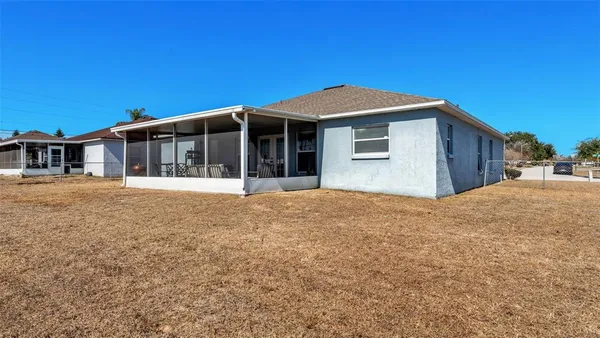 a view of a house with a backyard