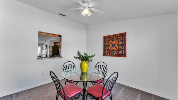 a view of a dining room with furniture and chandelier