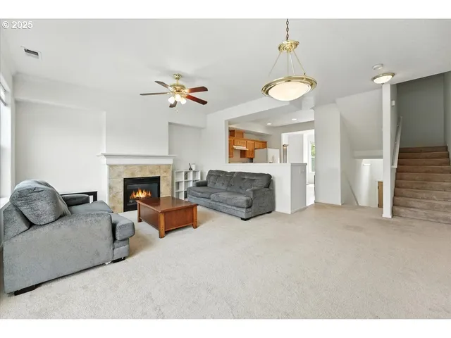a living room with furniture a fireplace and a chandelier