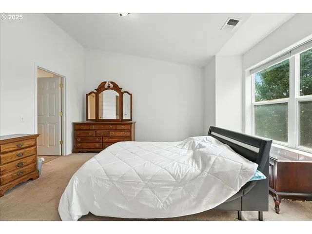 a bedroom with a bed and window