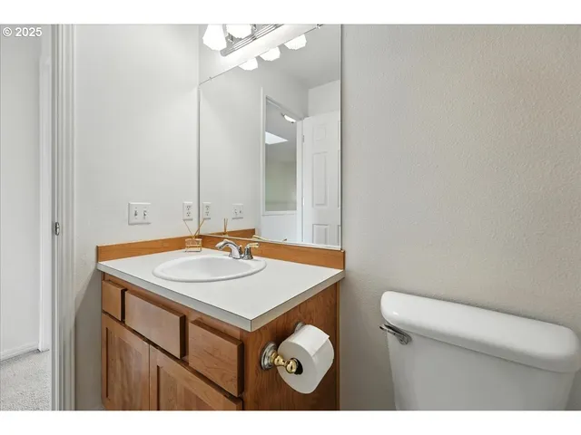 a bathroom with a sink a toilet and a mirror