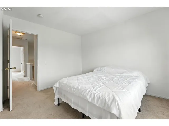 a large white bed in a white room