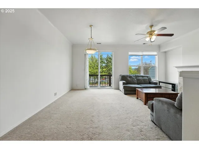 a living room with furniture a fireplace and a chandelier
