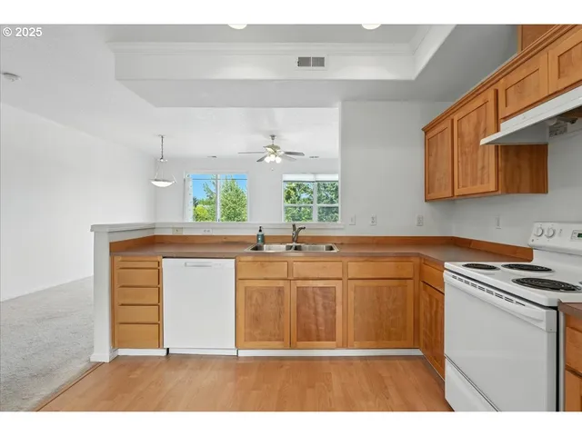 a kitchen with stainless steel appliances a sink stove and cabinets