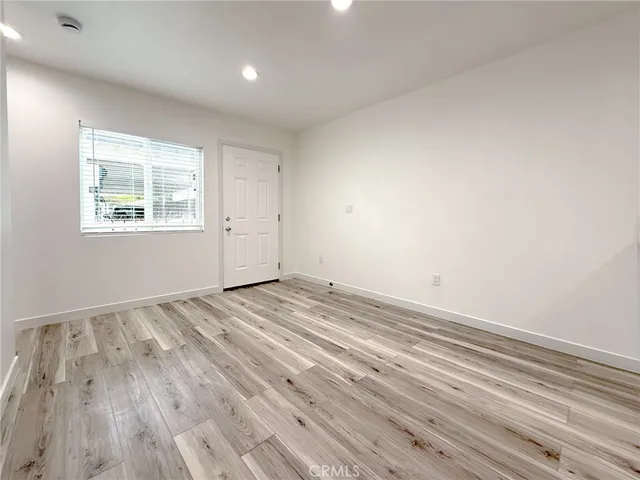 a view of room with window and wooden floor