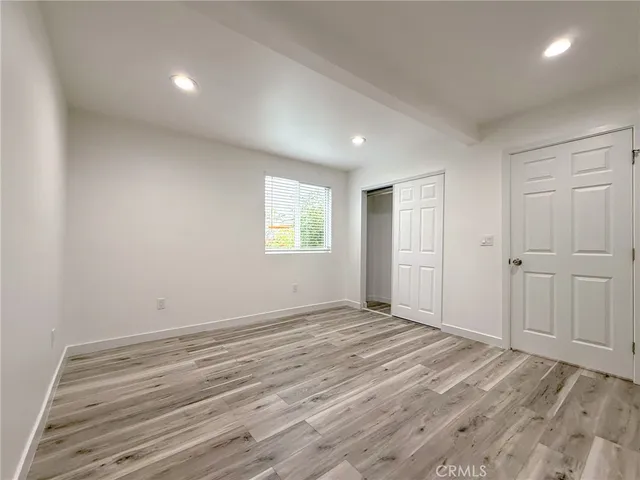 a view of a room with wooden floor and closet
