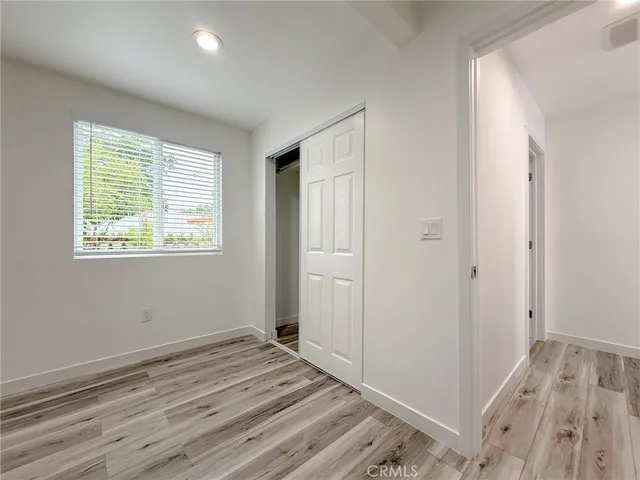 a view of room with wooden floor and fan