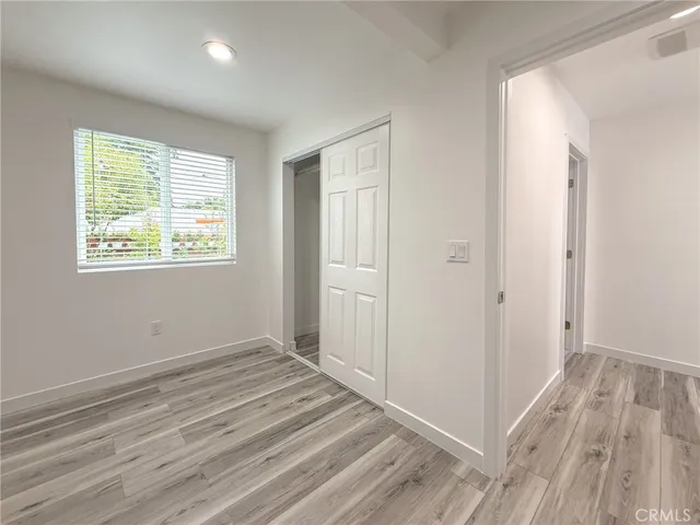 a view of a room with wooden floor and windows