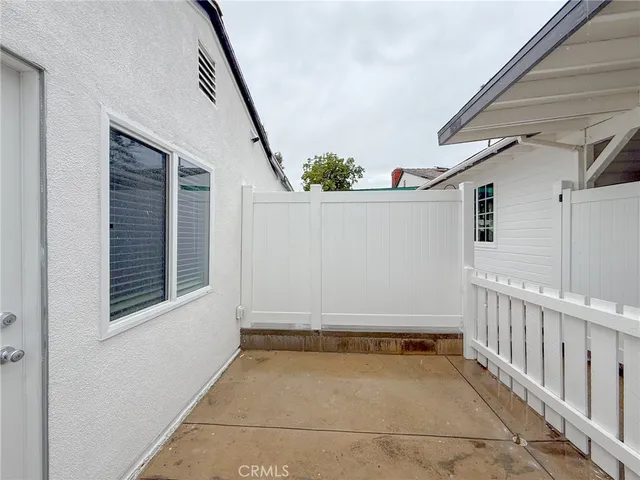 a view of a room with furniture and a window