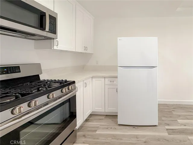 a kitchen with a stove and a microwave