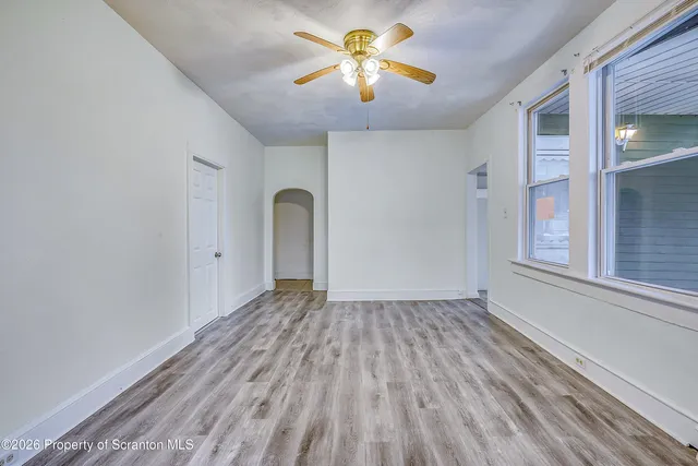a view of room with window and ceiling fan
