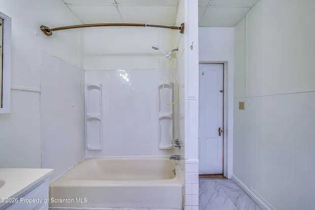 a bathroom with a bathtub and a shower