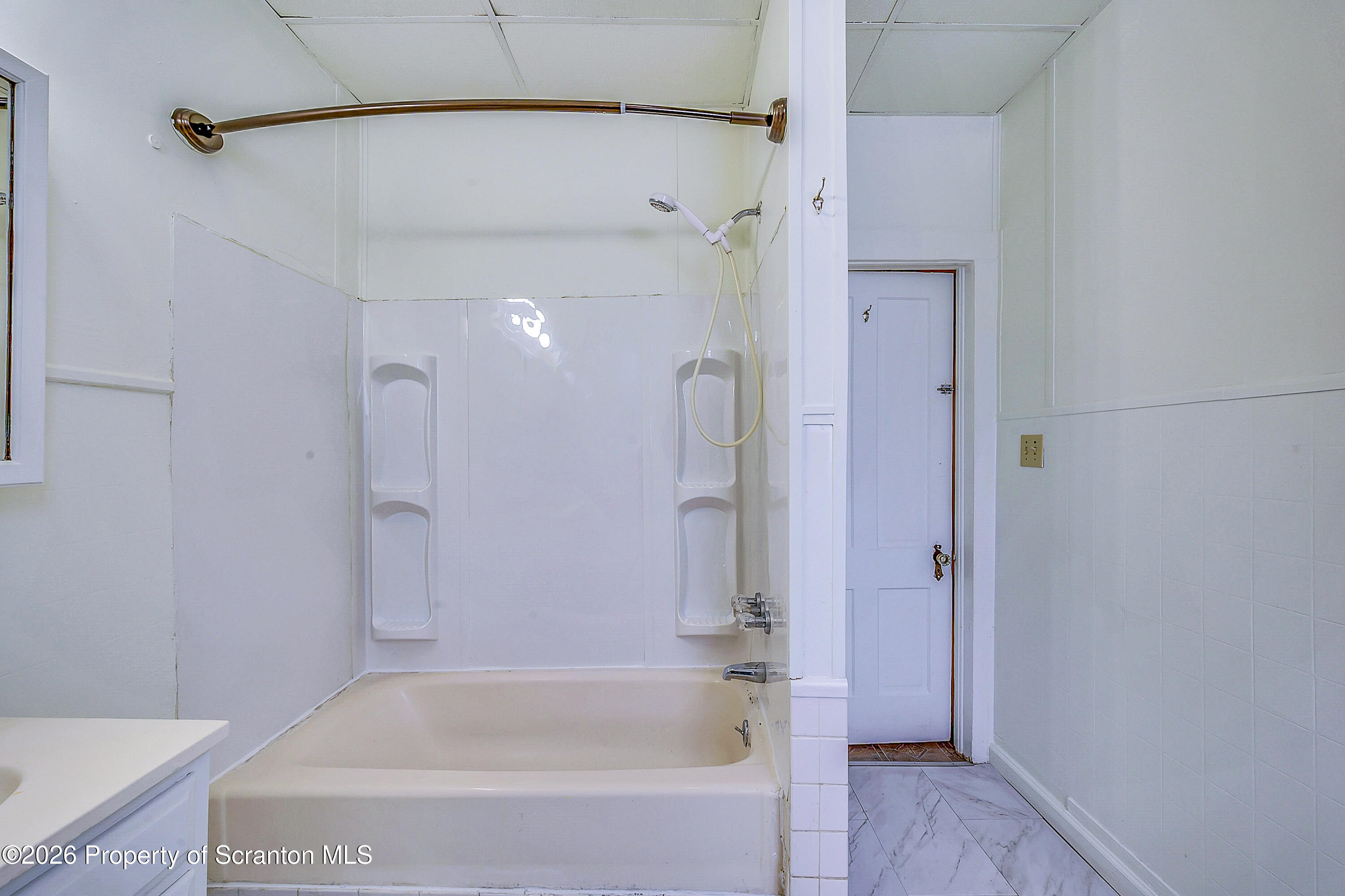 228 North Main Street Taylor, PA 18517 - Photo 16 of 19 a bathroom with a bathtub and a shower
