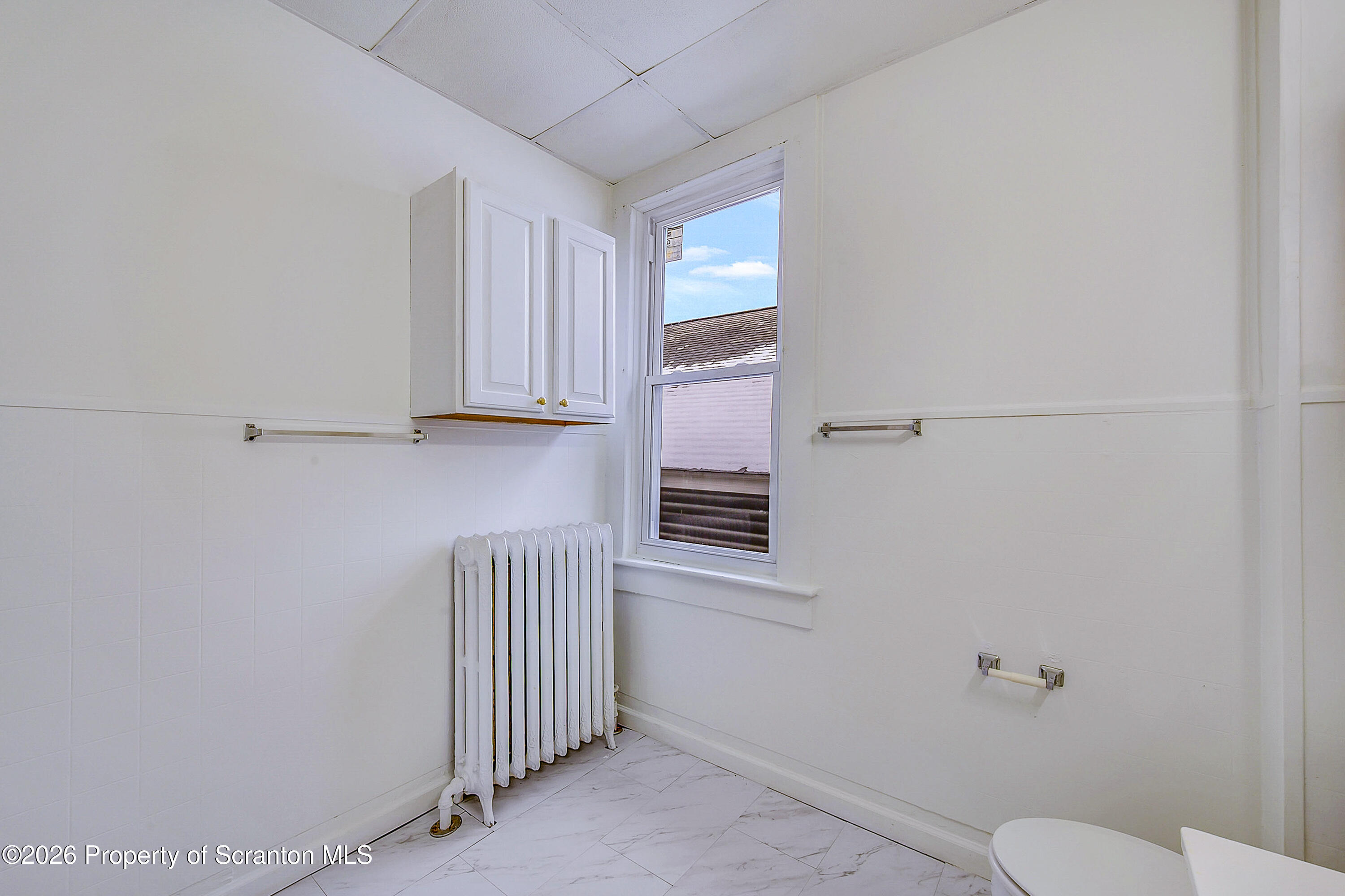 228 North Main Street Taylor, PA 18517 - Photo 17 of 19 a bathroom with a sink a toilet and mirror