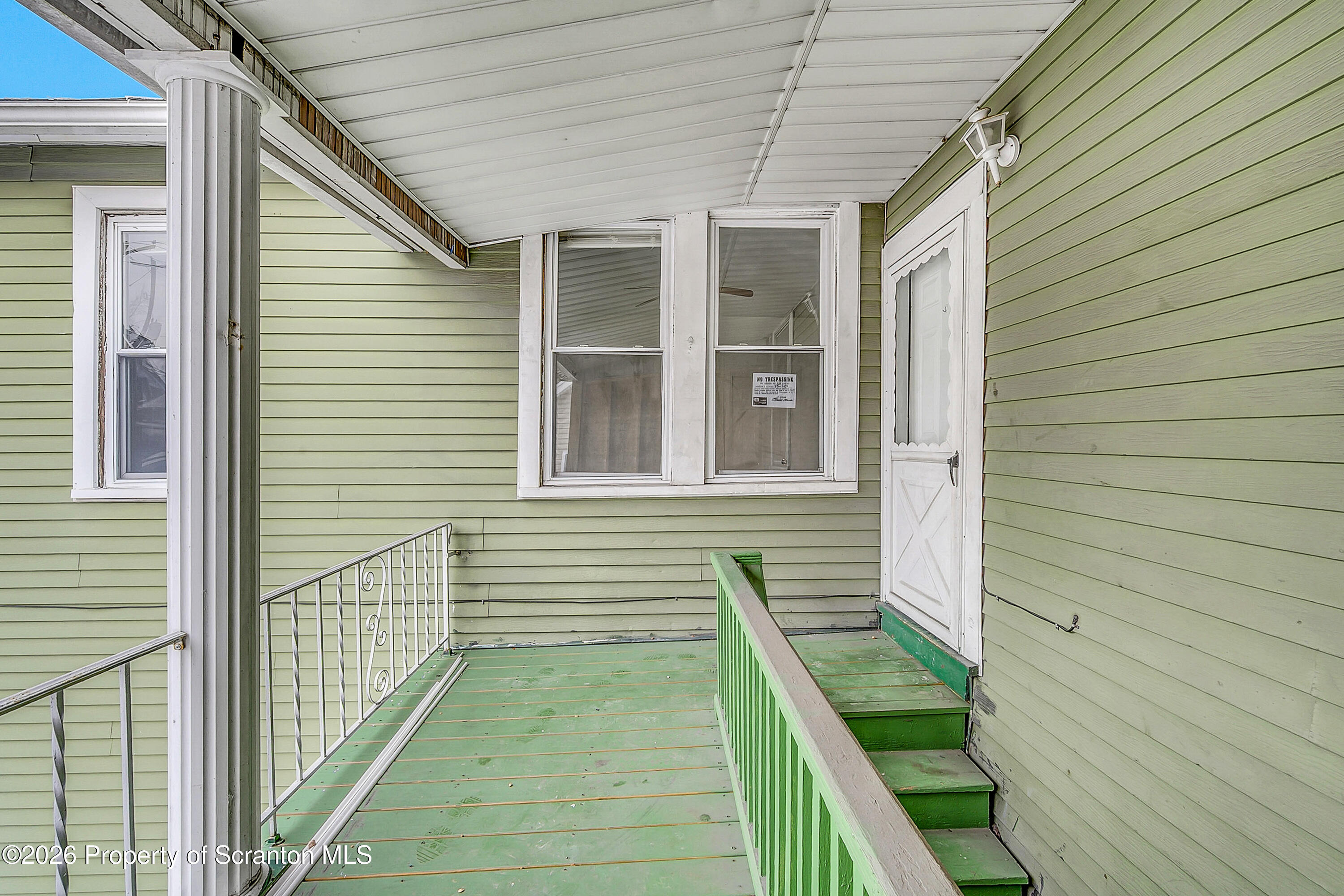 228 North Main Street Taylor, PA 18517 - Photo 3 of 19 a view of a balcony with two chairs and a barbeque