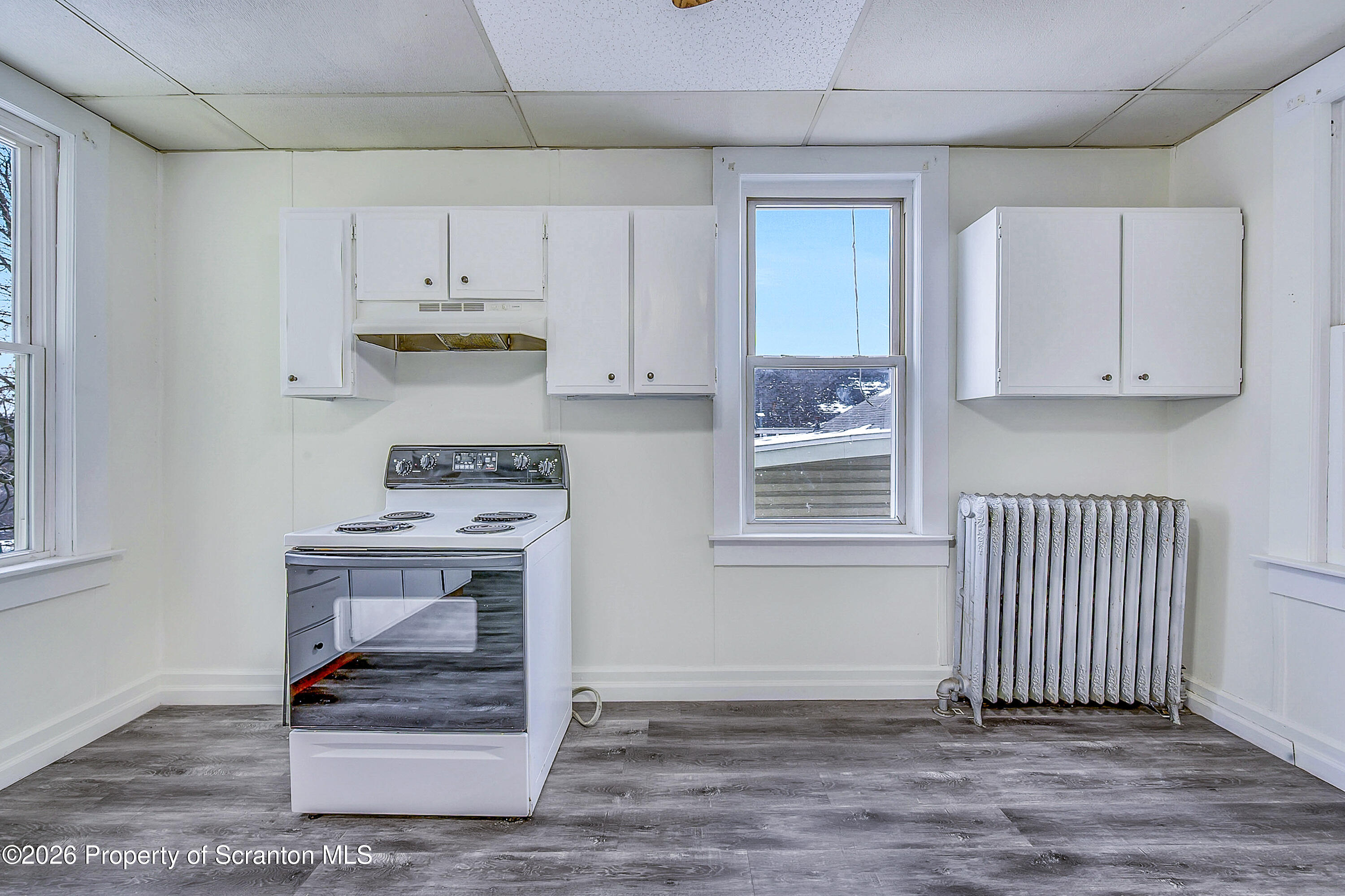 228 North Main Street Taylor, PA 18517 - Photo 6 of 19 a view of kitchen with wooden floor and cabinets