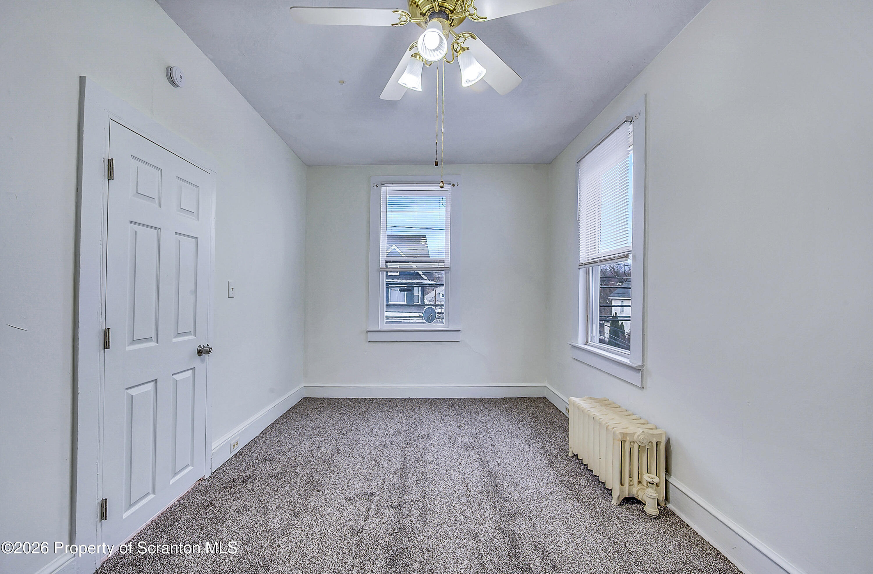 228 North Main Street Taylor, PA 18517 - Photo 8 of 19 a view of an empty room with a window