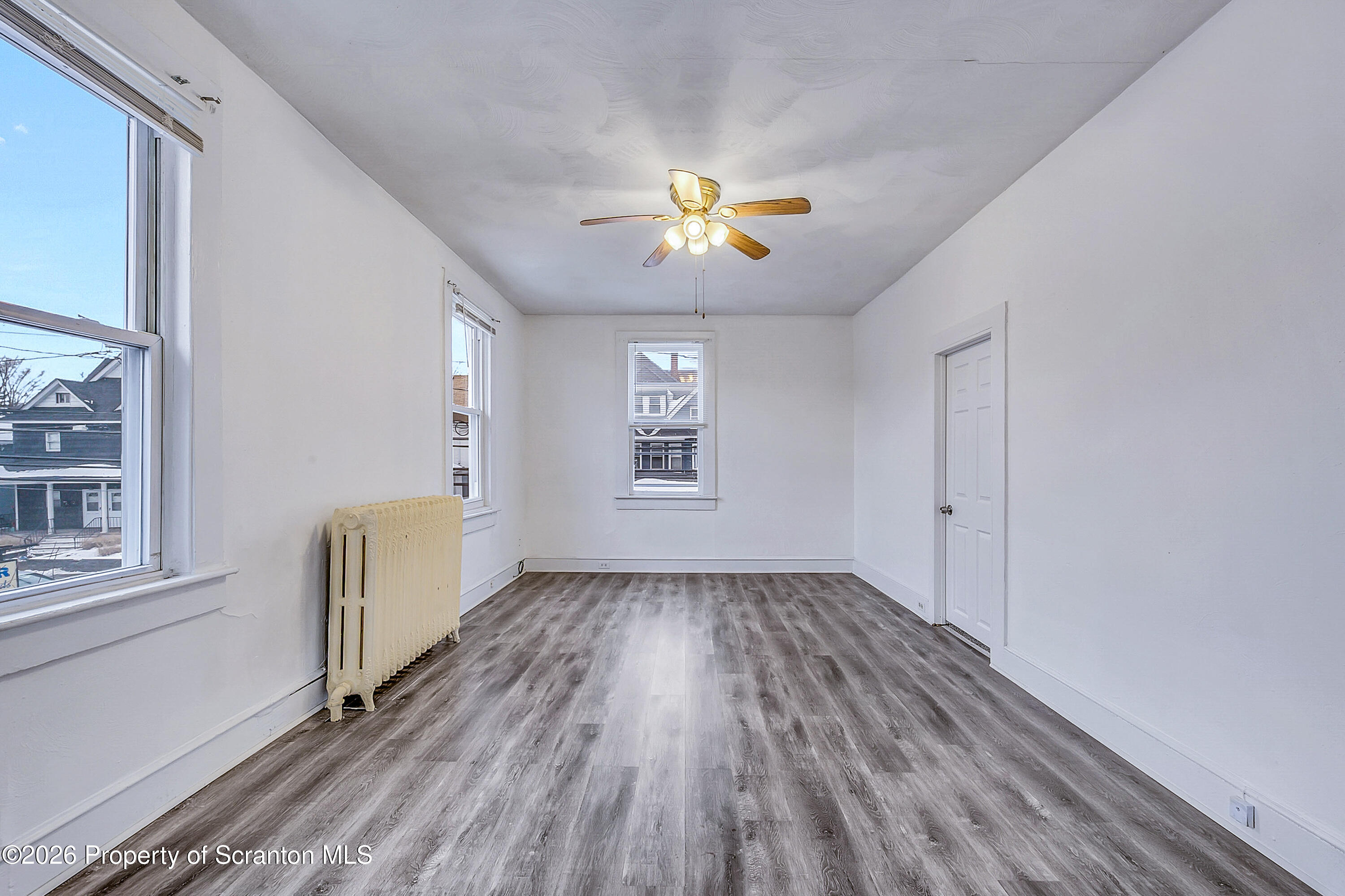 228 North Main Street Taylor, PA 18517 - Photo 10 of 19 wooden floor in an empty room with a window