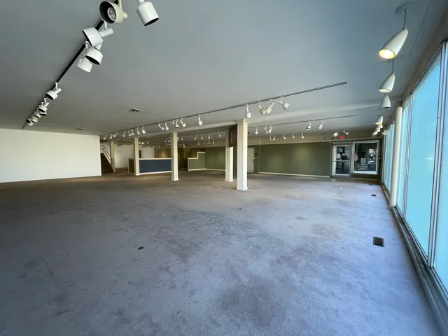 a view of a big room with closet and chandelier