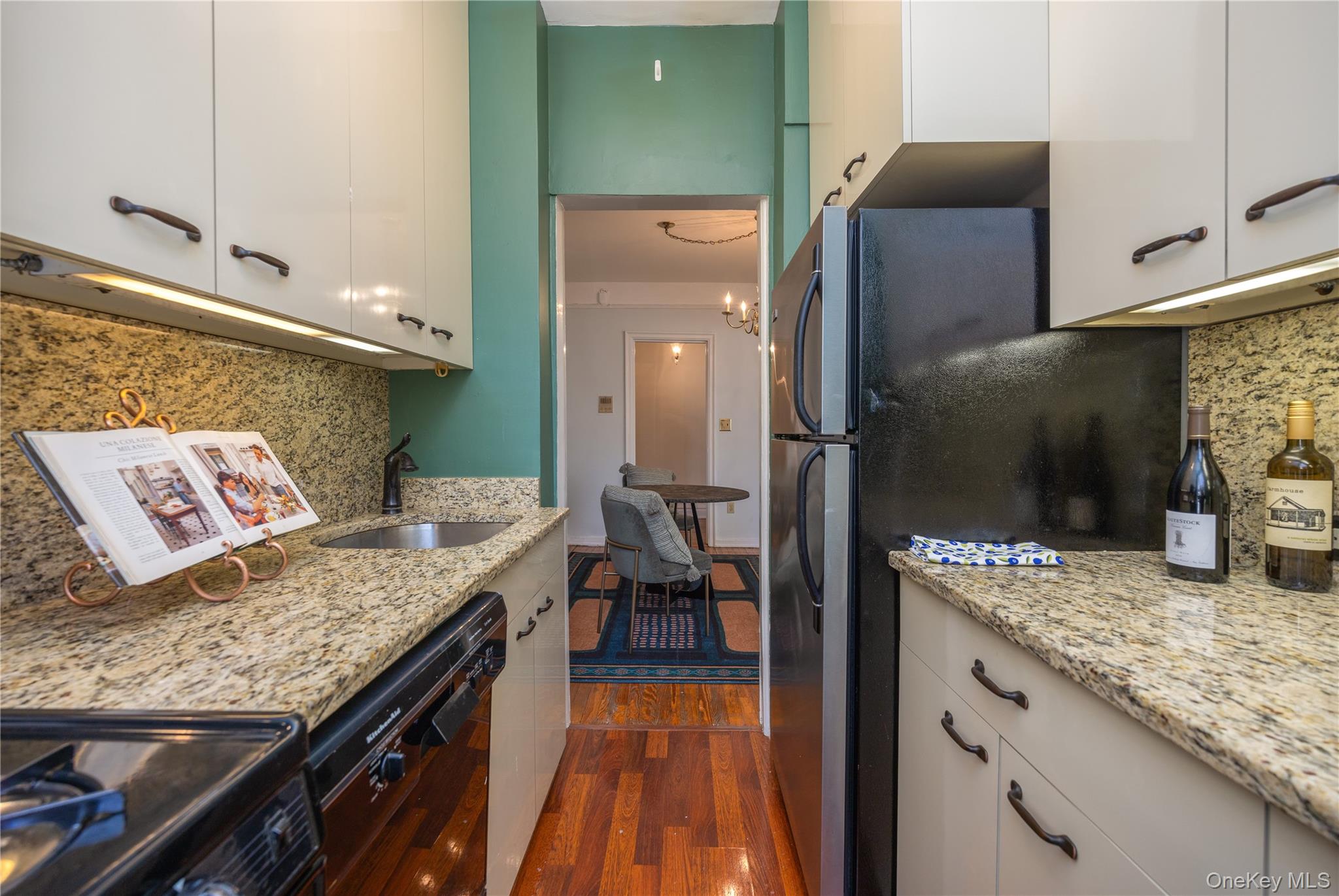 25 Parkview Avenue, Unit 2K Bronxville, NY 10708 - Photo 21 of 26 a kitchen with granite countertop kitchen island stainless steel appliances a sink stove and refrigerator