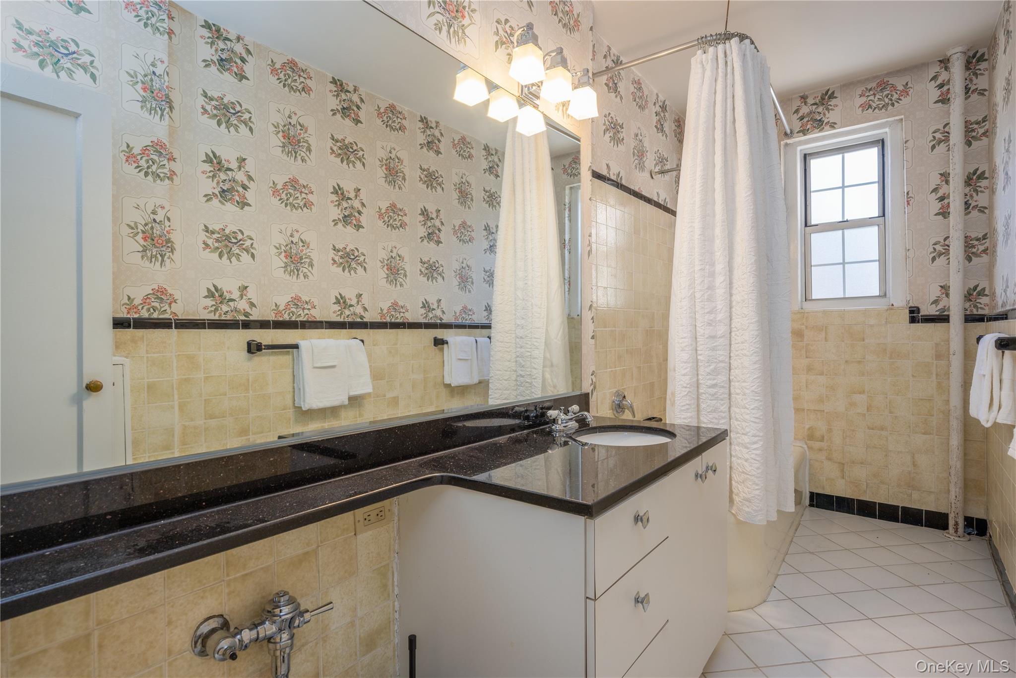 25 Parkview Avenue, Unit 2K Bronxville, NY 10708 - Photo 22 of 26 a view of a bathroom with a sink a mirror and a shower