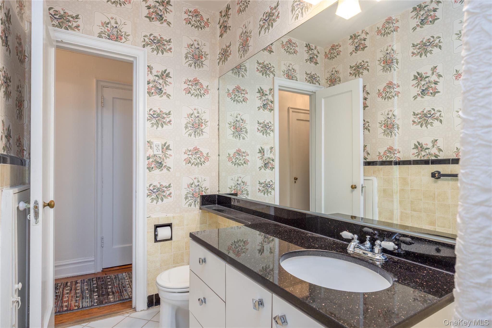 25 Parkview Avenue, Unit 2K Bronxville, NY 10708 - Photo 24 of 26 a bathroom with a granite countertop sink and a mirror